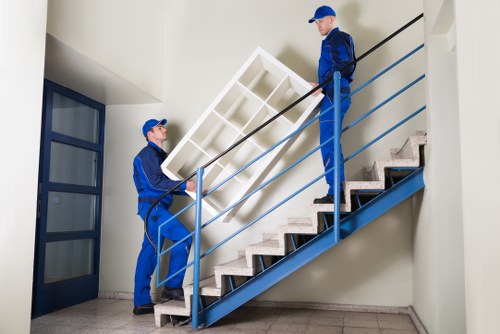 Movers carrying furniture through a Wandsworth property entrance